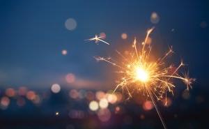 A sparkler with lights in background